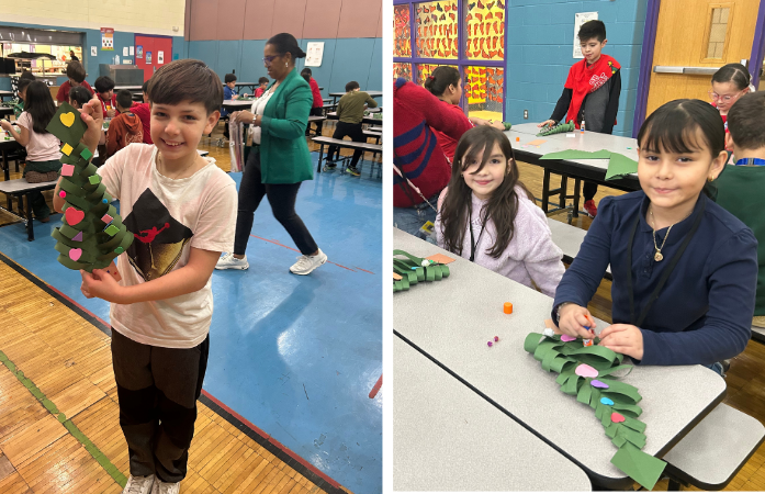 students posing with their decorated paper christmas trees